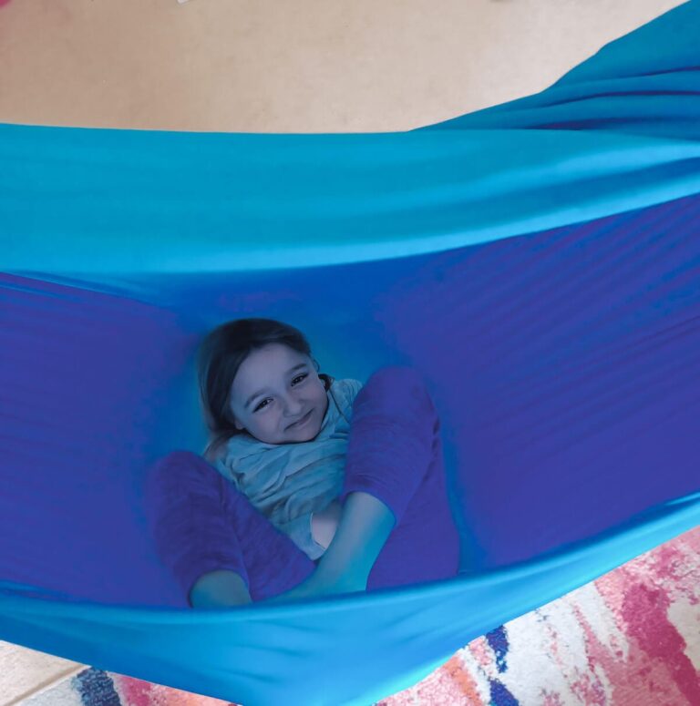 Using a sensory swing during homeschool breaks to help a child with ADHD regain focus.